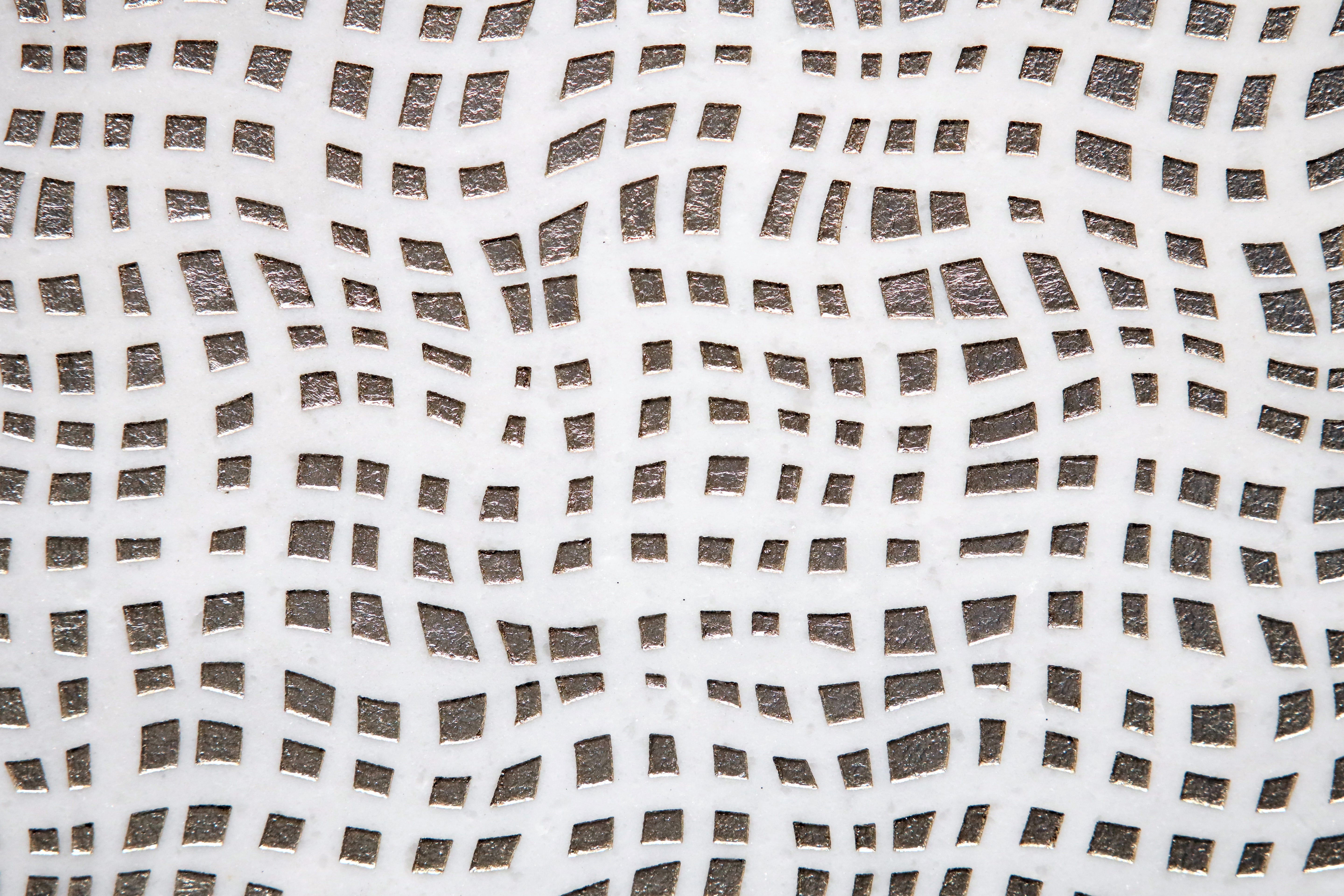 Close-up of textured white marble tile showing layered surface detail