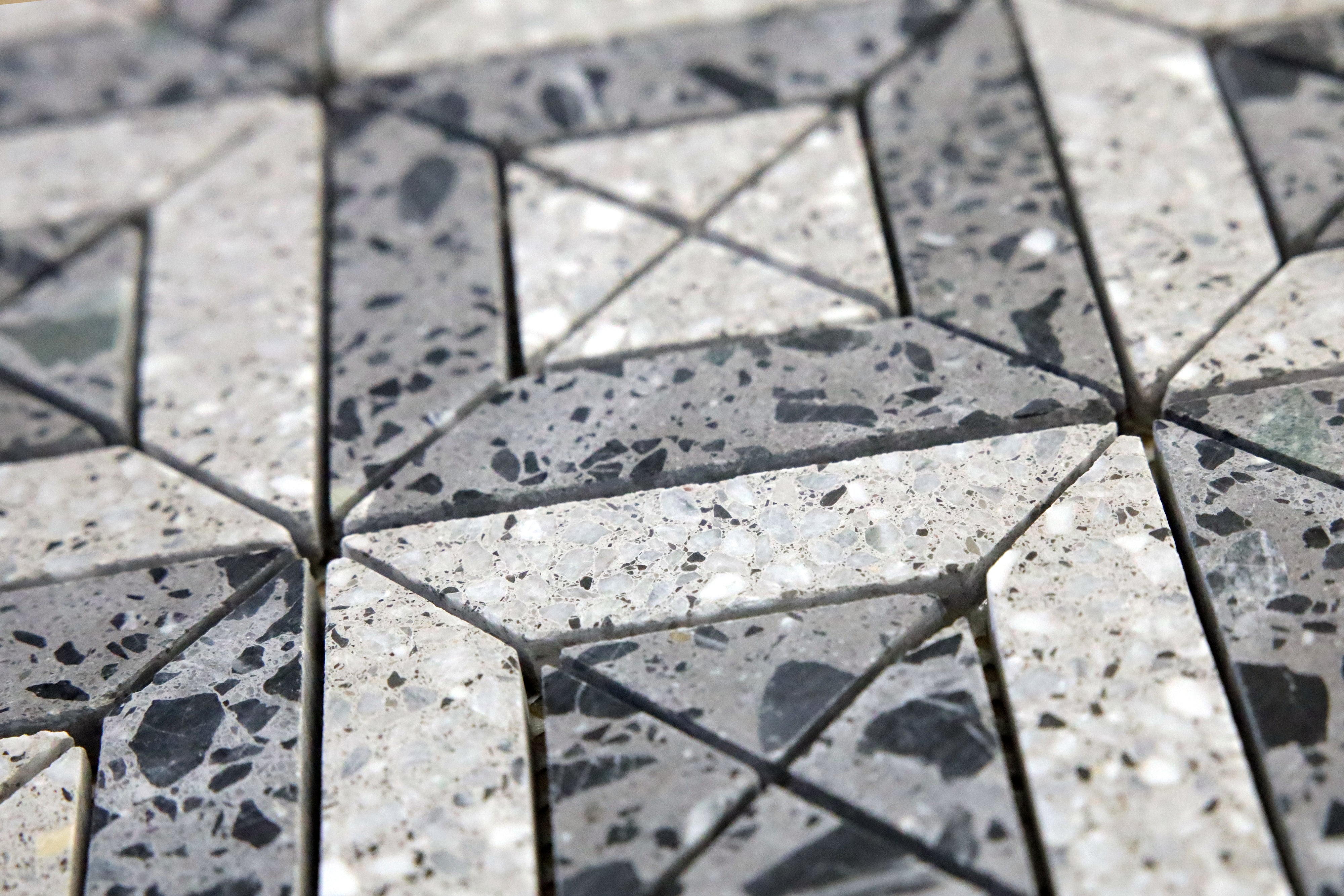 Close-up of grey terrazzo tile showing aggregate texture and pattern