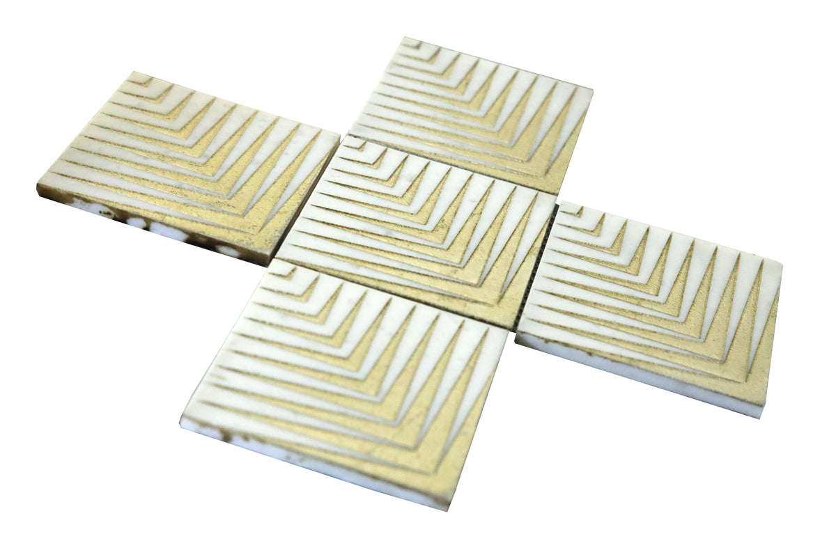 Close-up of Agape White marble mosaic tile with gold geometric detailing