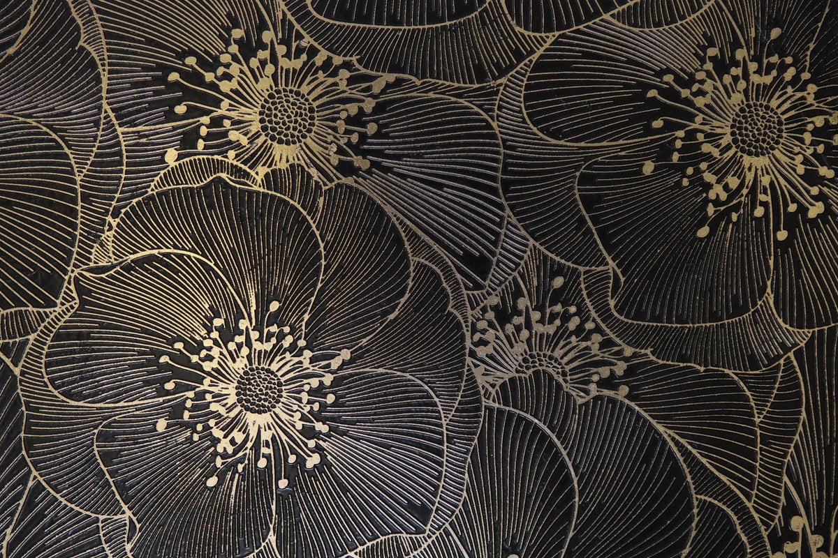 Close-up of Golden Blossom Nero decorative tile showing engraved floral detailing